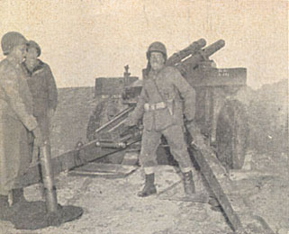 [Attached ordnance team checks an artillery piece]